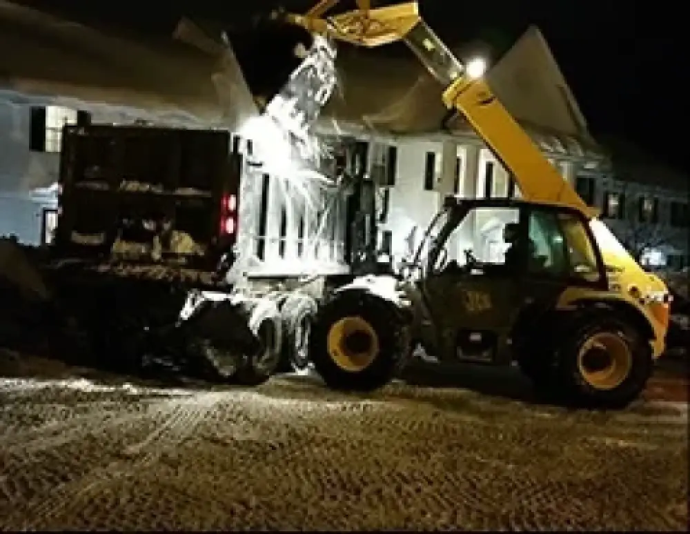 Commercial snow removal crew clearing pavement
