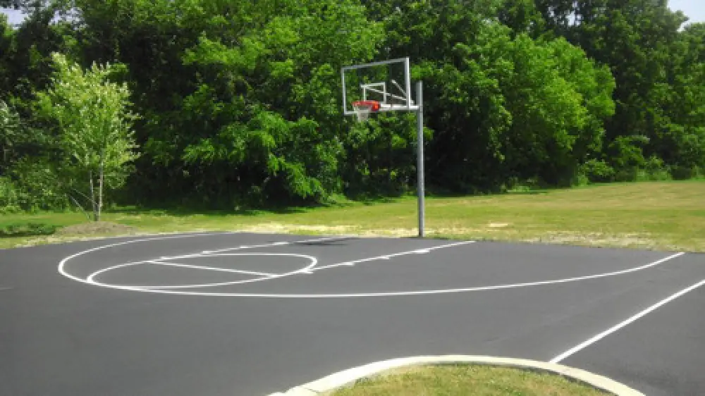 Striped basketball court on a paved surface
