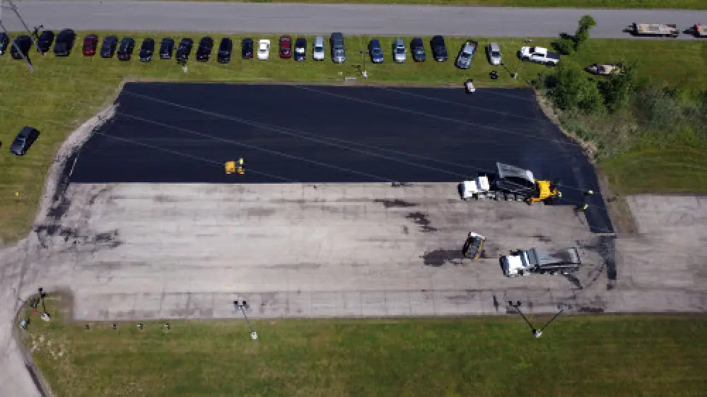 Asphalt repair work on damaged pavement