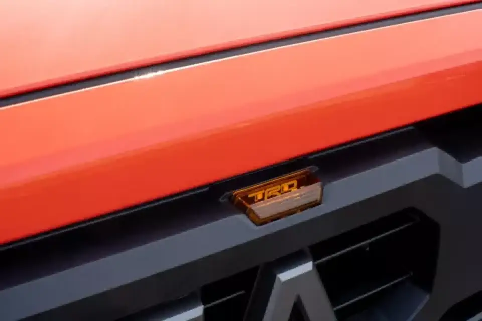 Side view of orange Toyota Tundra TRD Pro with protective film applied