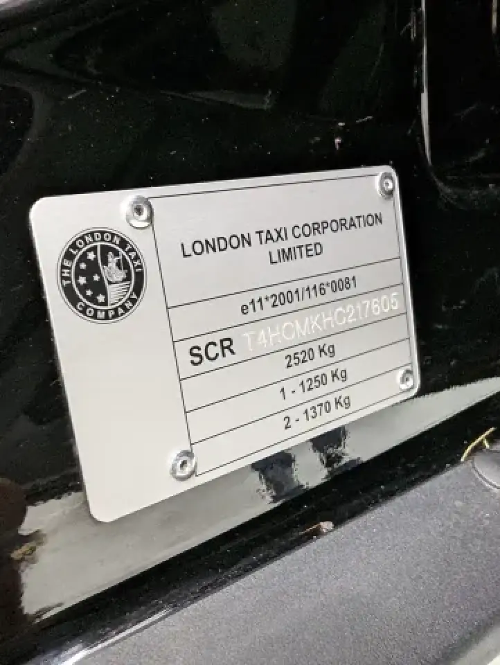 London Taxi Company badge close up on black taxi body