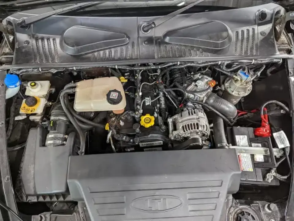 London taxi engine bay with visible components and reservoirs