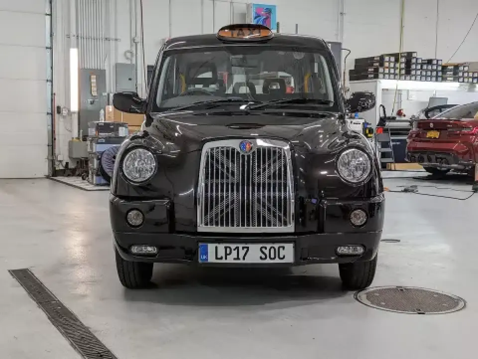 black London taxi rear view with UK license plate in garage