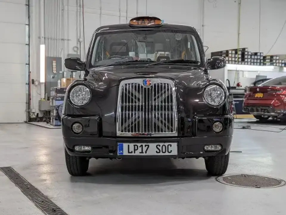 classic London black taxi with roof taxi sign inside garage