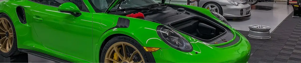 green car with the hood open