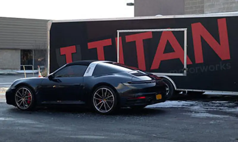 dark car in front of trailer