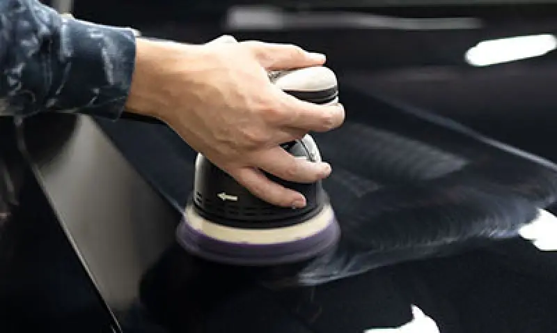man providing paint correction