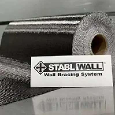 A roll of black wall bracing material next to a card labeled STABL WALL Wall Bracing System.