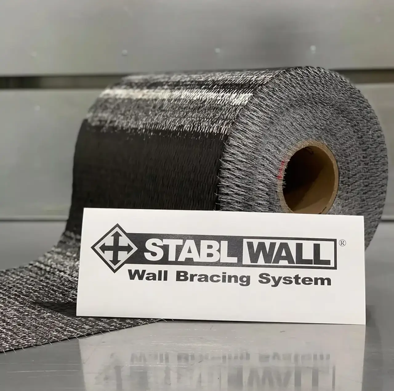 A roll of wall bracing material next to a card labeled STABL WALL Wall Bracing System.