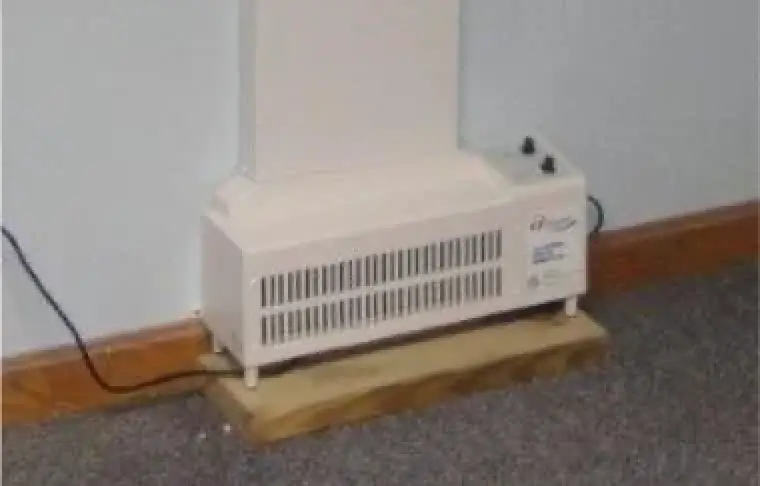 An indoor EZ Breathe ventilation system on the floor of a room.