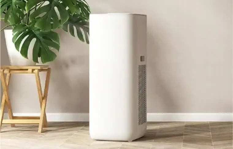A white dehumidifier on the floor of a room.