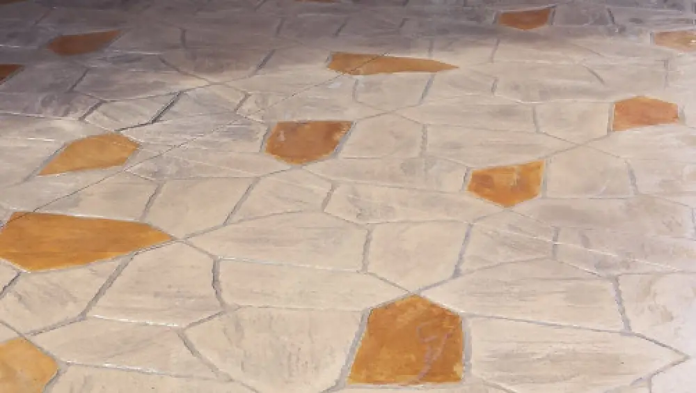 Textured stone floor with irregular tan tiles and some larger tiles in a darker brown shade.