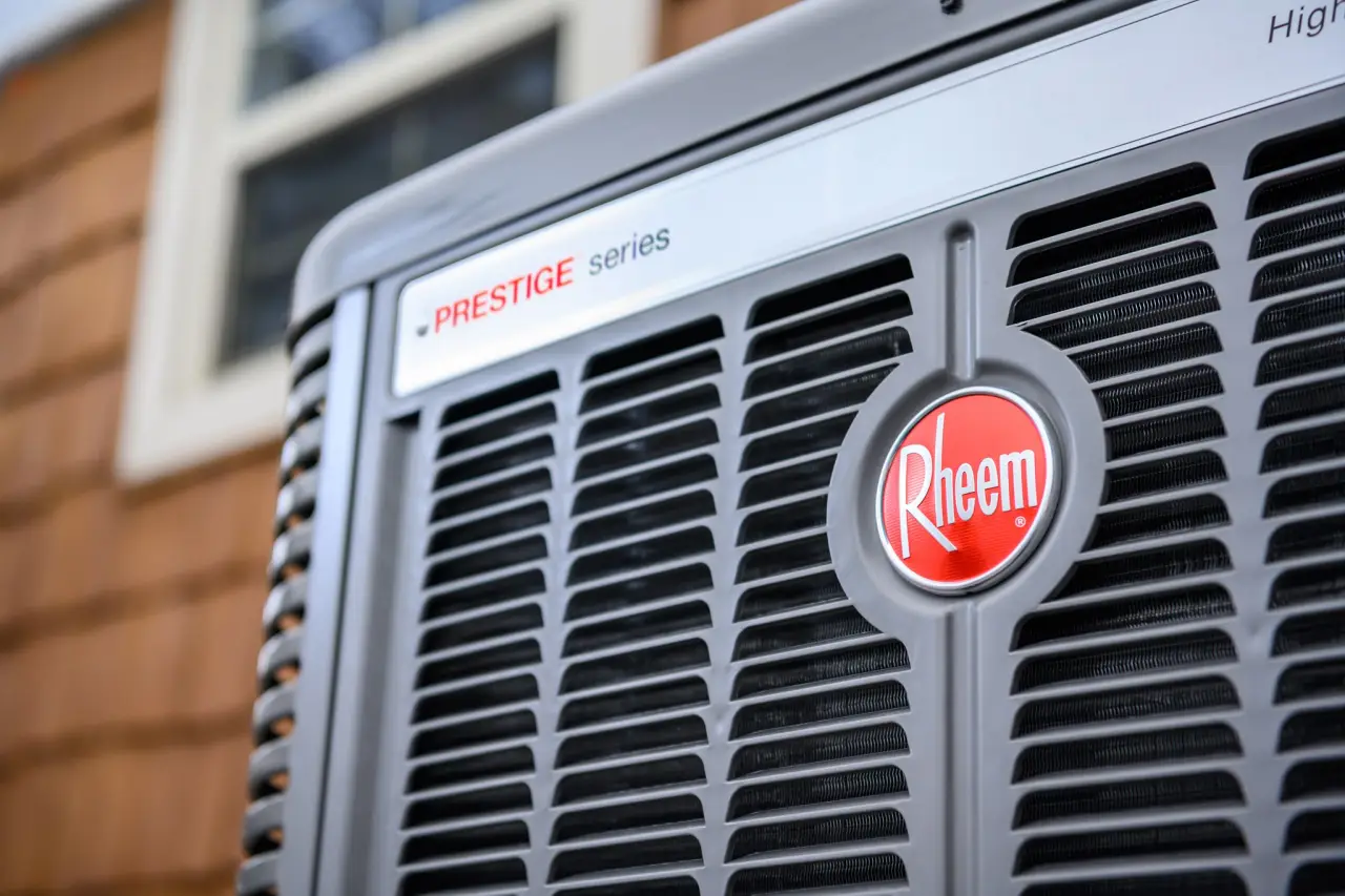 Rheem air conditioner unit with Prestige Series branding.