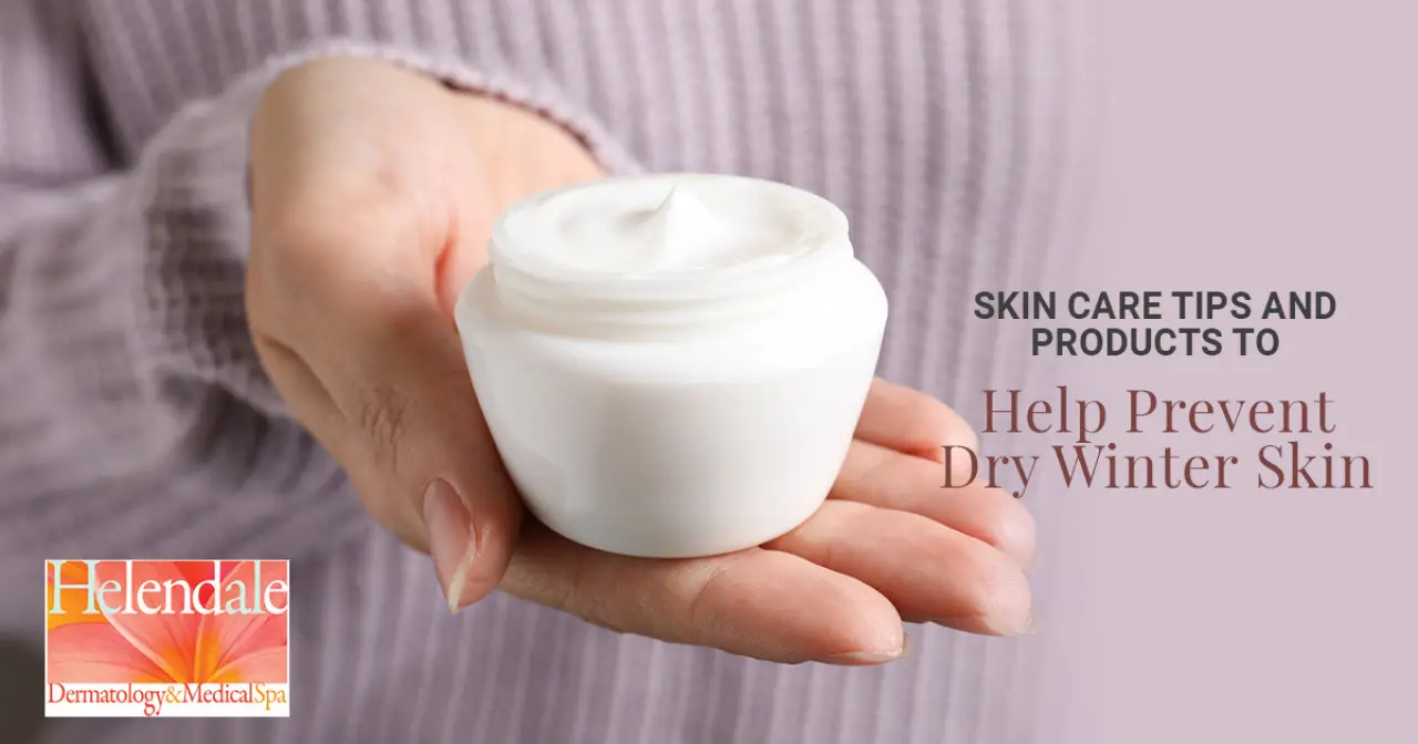 Hands holding an open jar of moisturizer for dry winter skin.