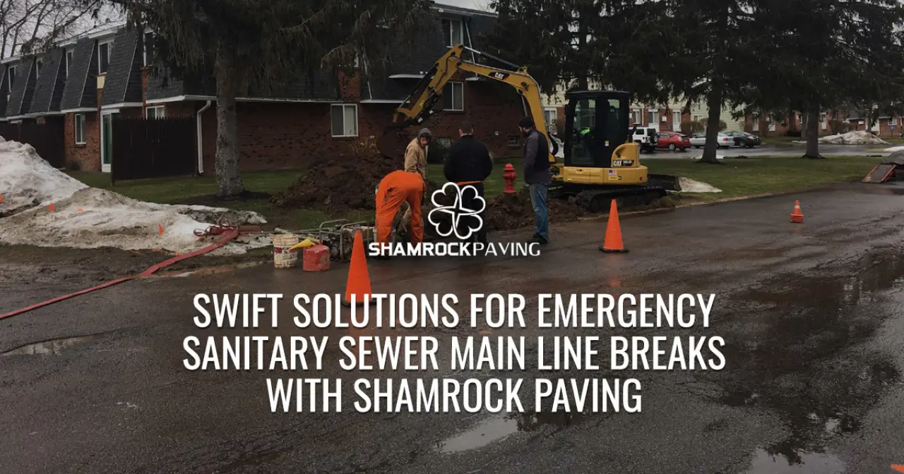 Crew and excavator repairing a sewer line on a wet street.