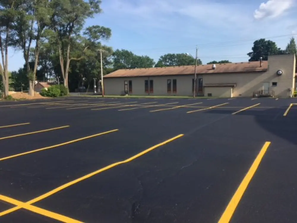 yellow parking lines on a newly paved commercial parking lot