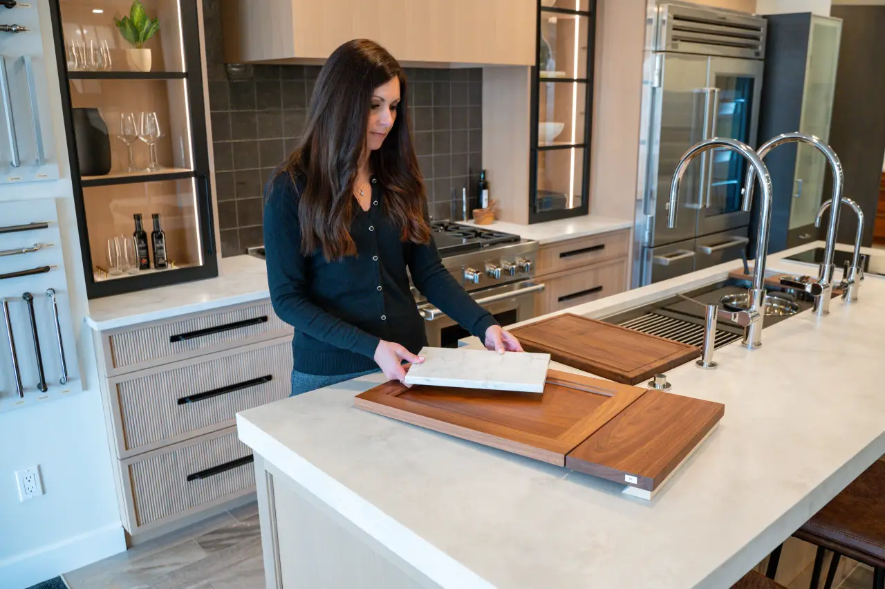 women at desk pointing at interior design plans