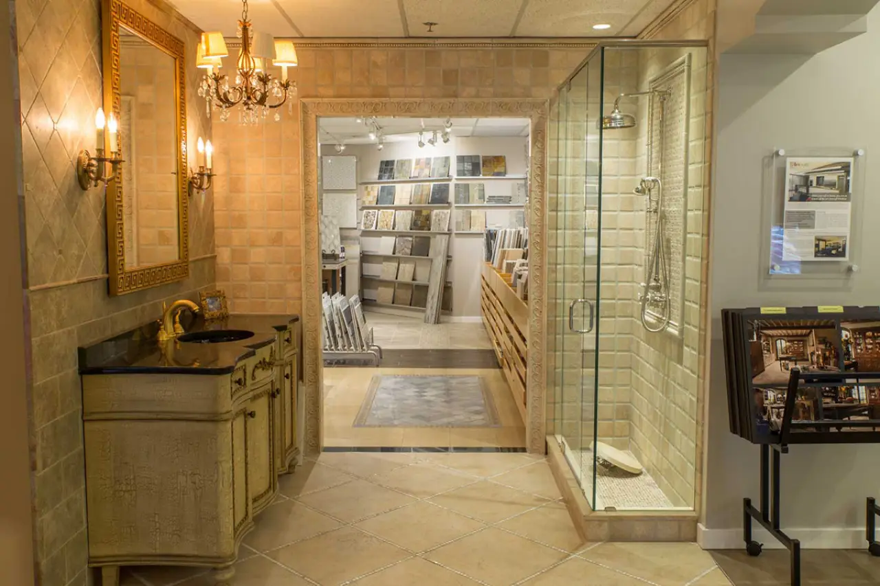 A bathroom sink and shower stall on display in a showroom.