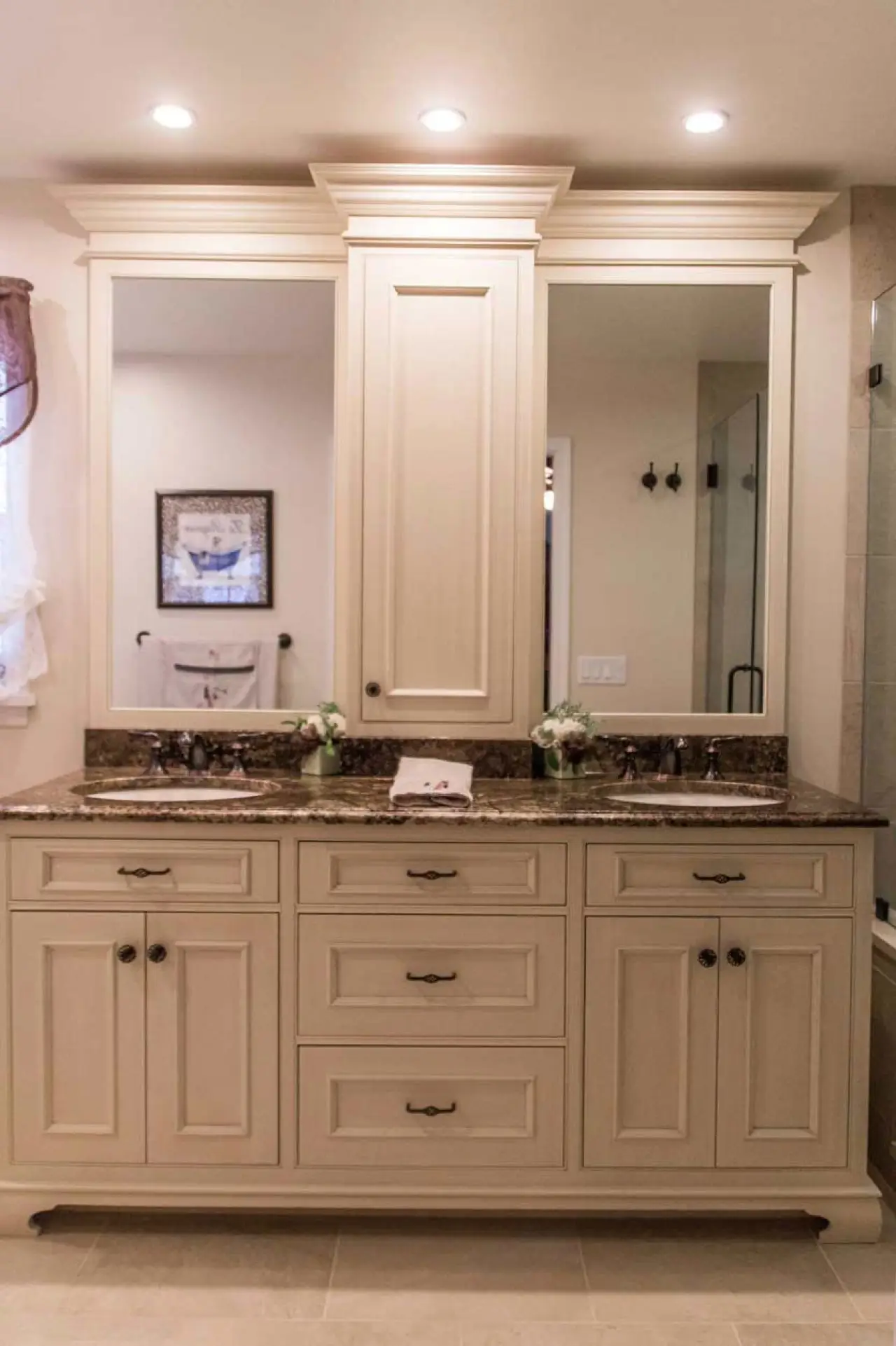 Earth-tone bathroom vanity with dual sinks, granite countertop, and inset cabinetry.