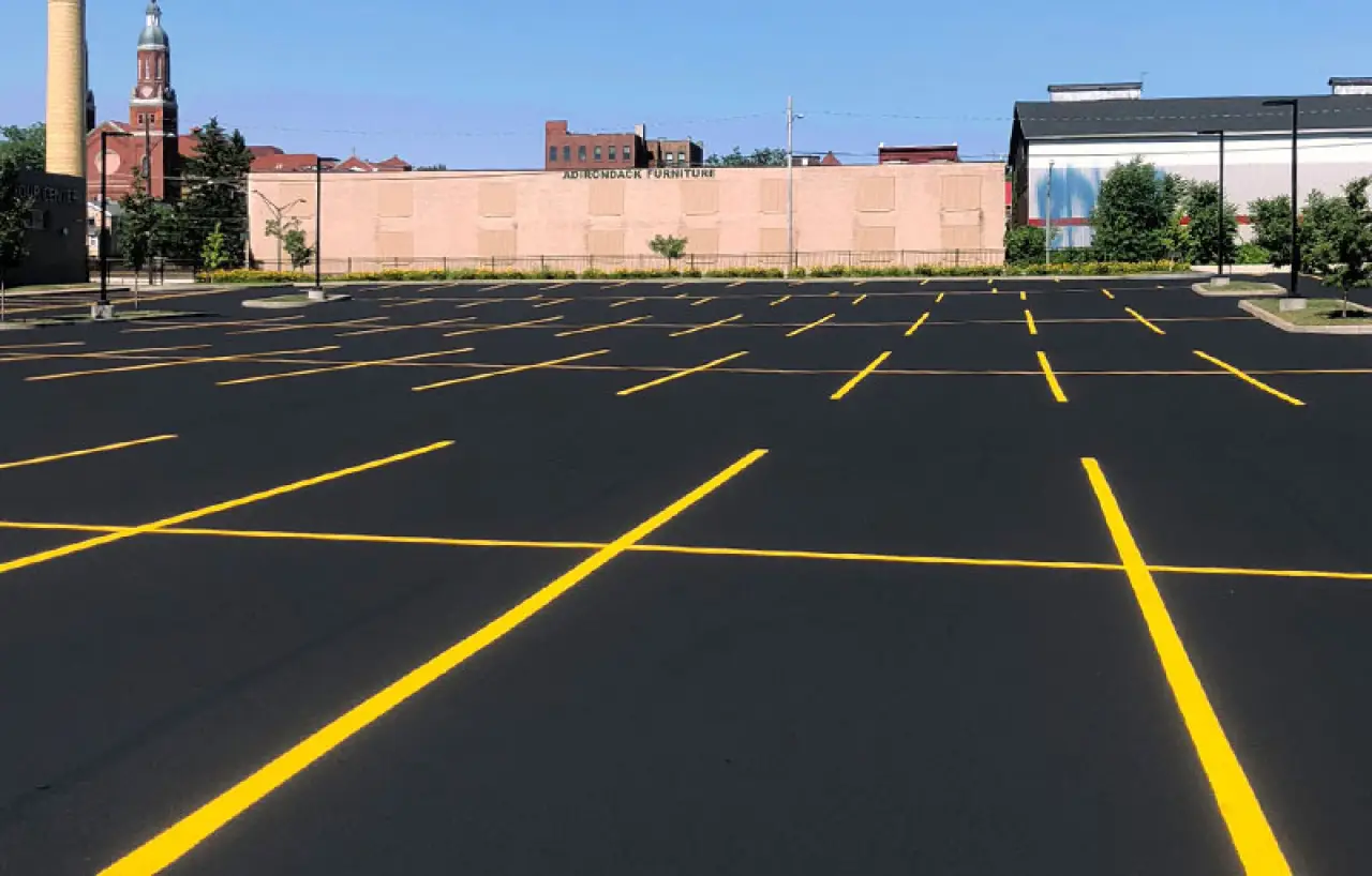 bright yellow parking lot stripes on fresh pavement