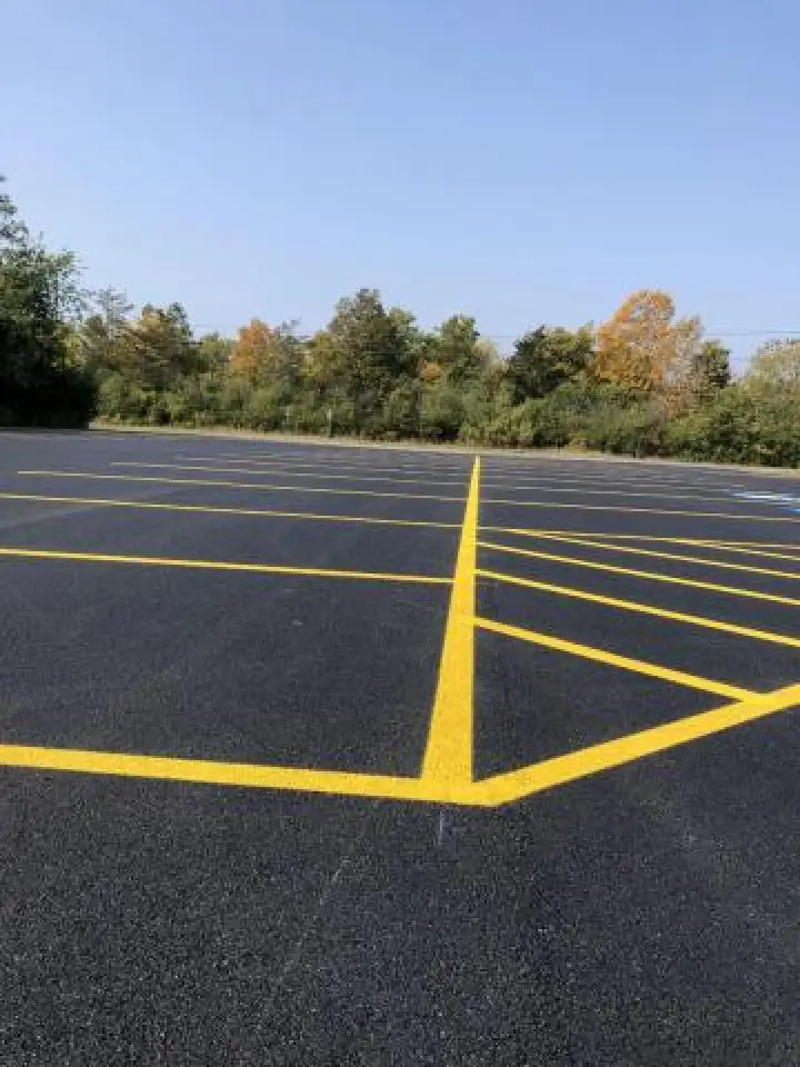 freshly striped parking lot with woods in background