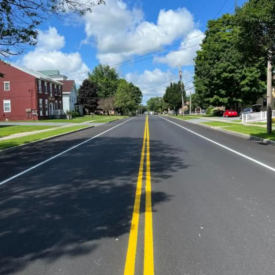 close up of road with freshly painted yellow double line