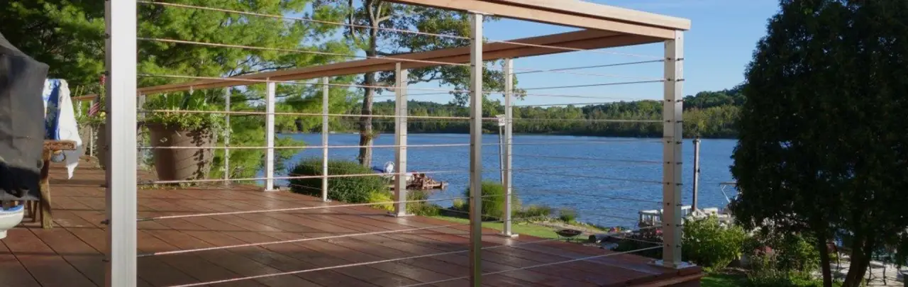 Deck with white cable railing overlooking a lake