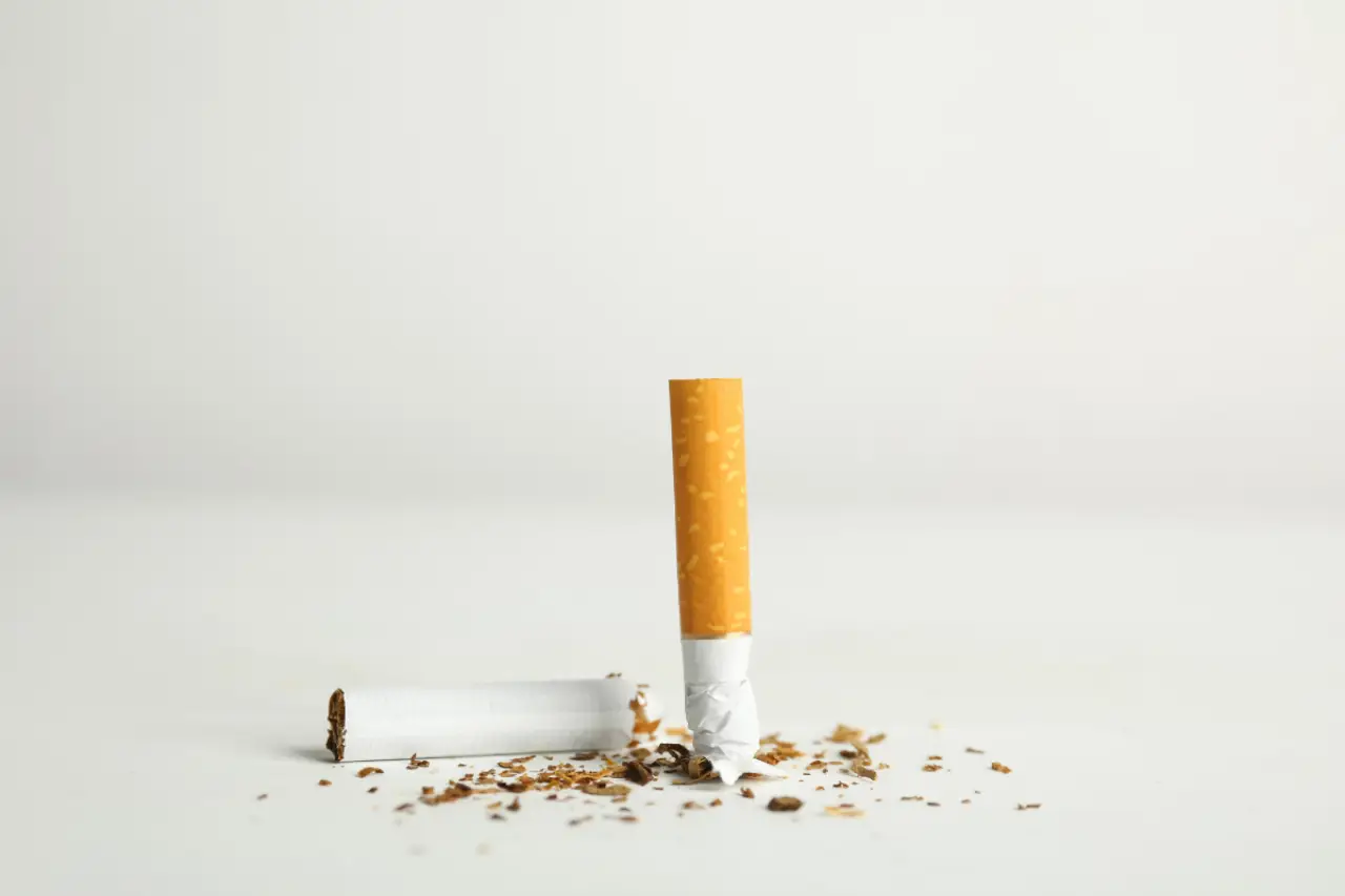 two halves of a cigarette shoved into the white ground