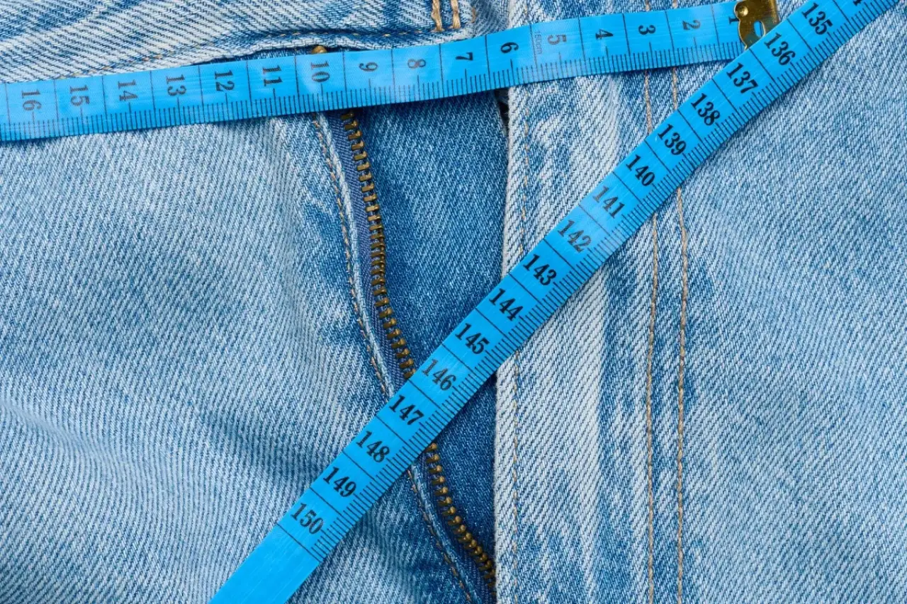 light blue denim jeans with a blue measuring tape