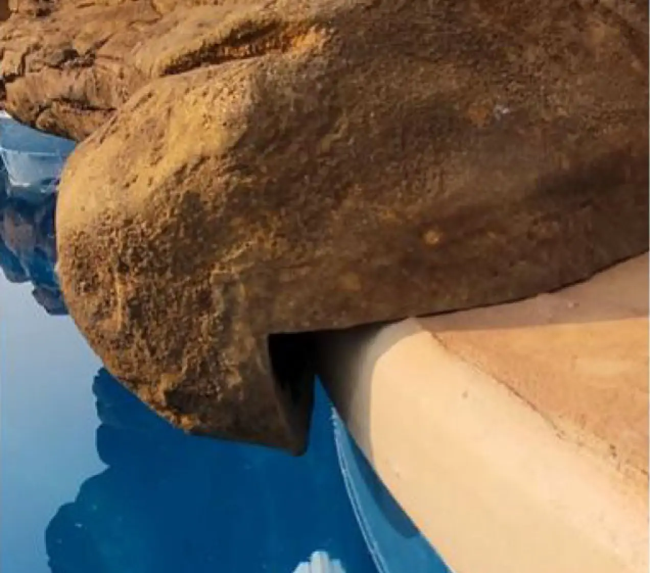 faux rock waterfall overhang on swimming pool