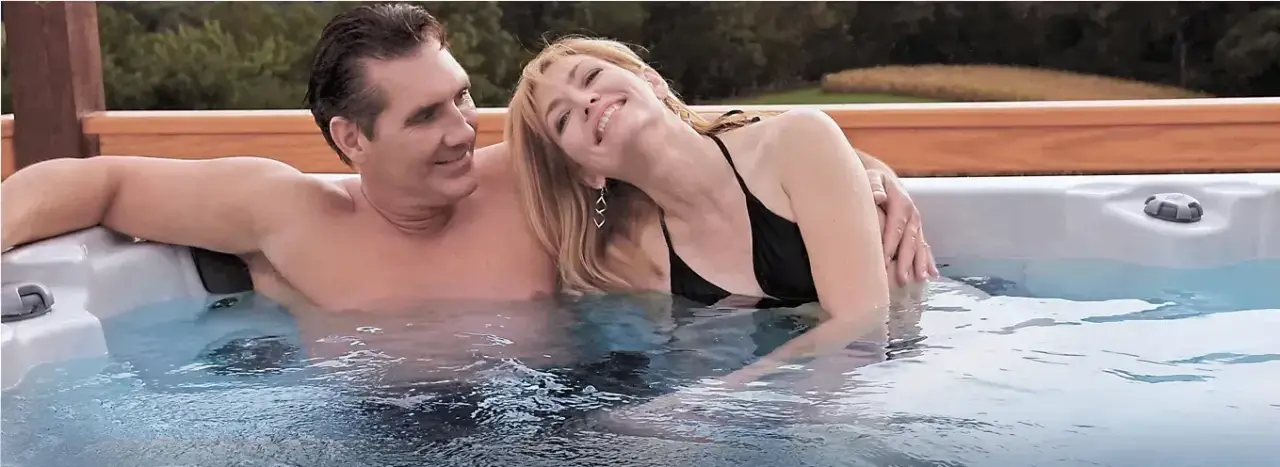 couple in relaxing in pdc spas hot tub