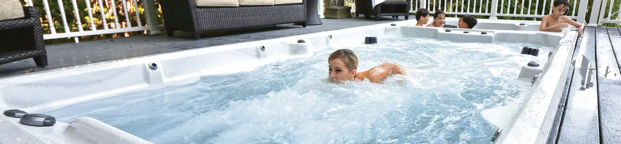 woman swimming in dual zone swim spa hot tub