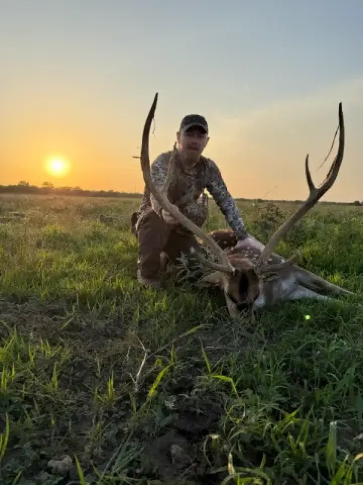 hunter with trophy axis buck