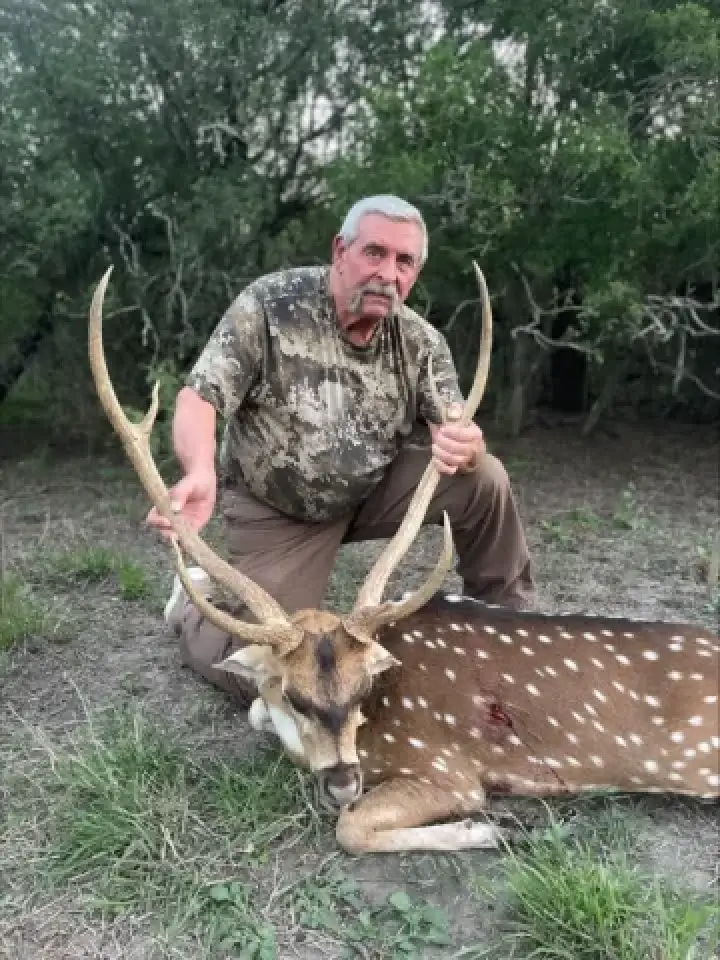 hunter wtih axis buck trophy