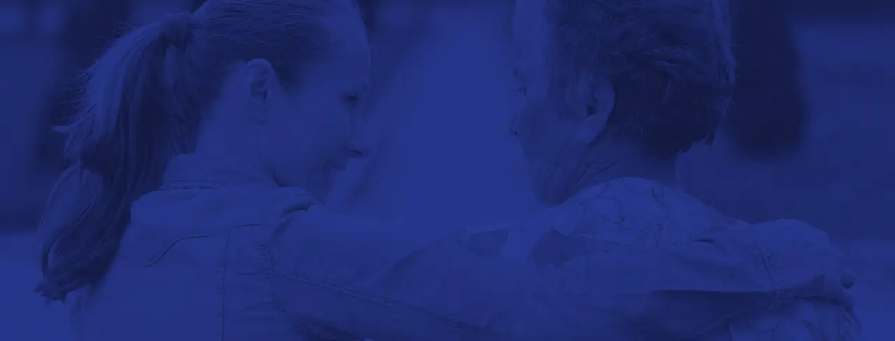 two people embracing one with a ponytail in a close supportive gesture blue overlay