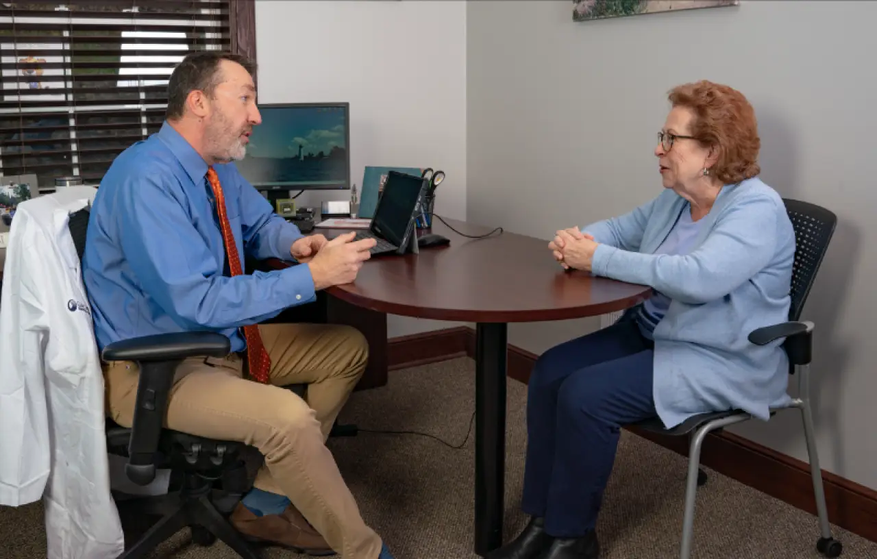 audiologist talking with patient
