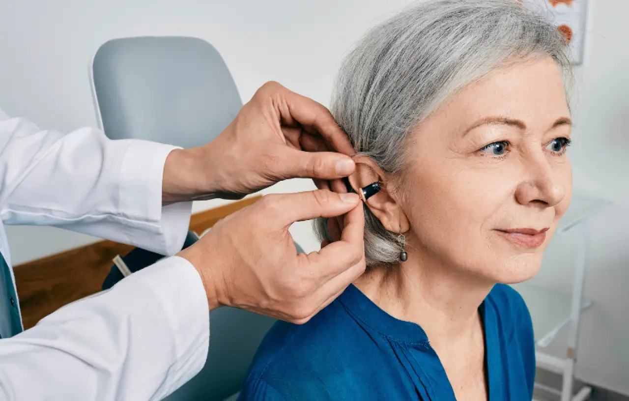 woman being fitted with hearing aid