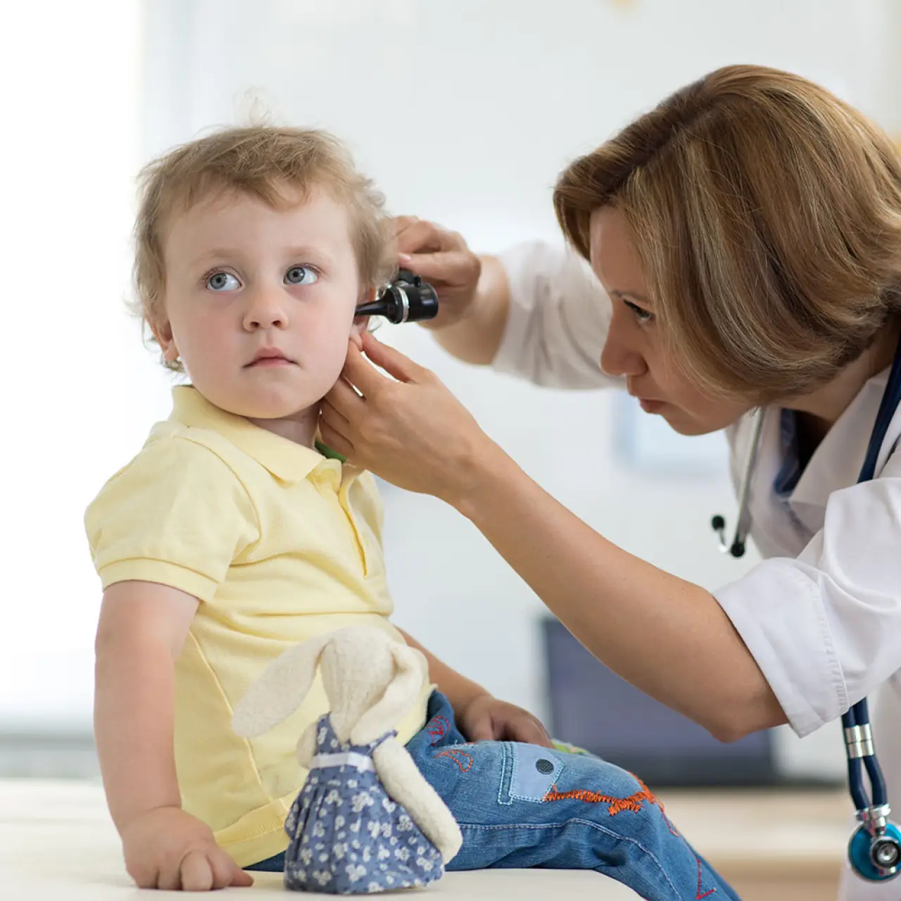 audiologist checking child ear