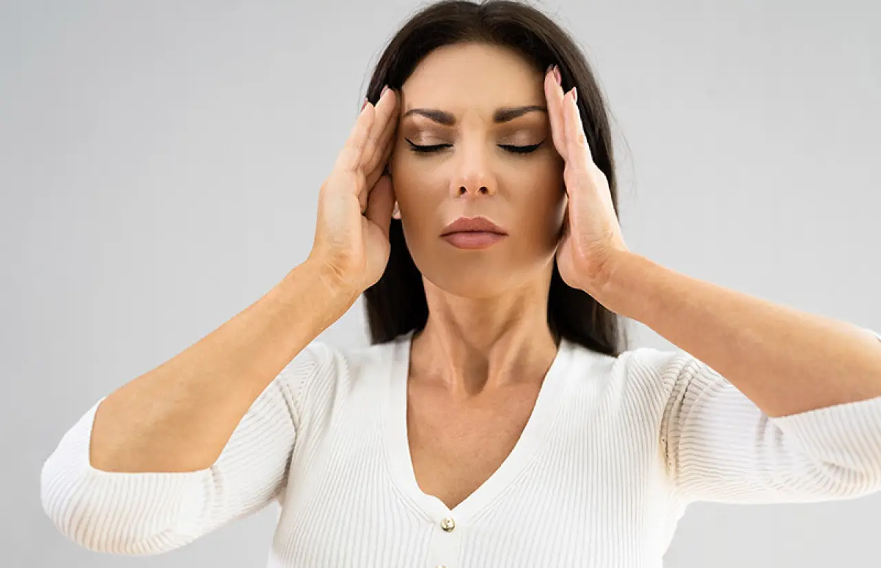 woman touching her head