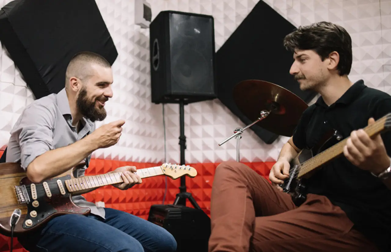 two men playing guitars