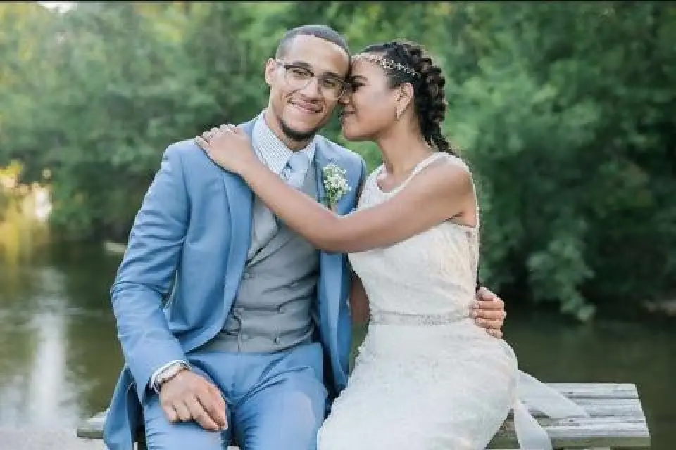 bride and groom by creek