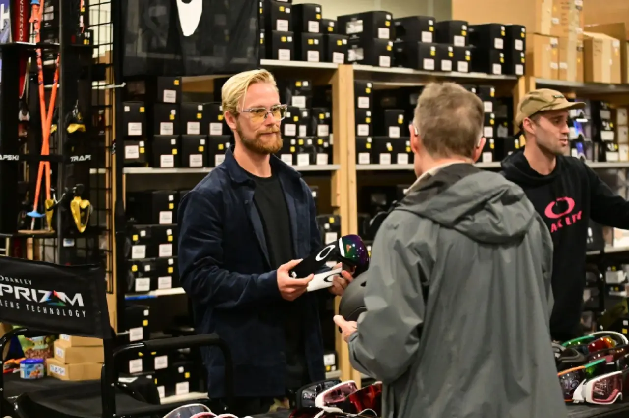 Customer examines ski goggles with an Oakley representative at the Ski Expo.