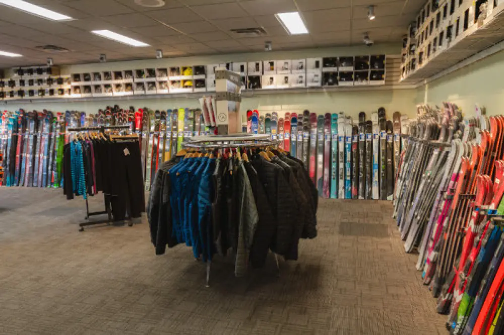 Wide shot of ski jackets, pants, and skis at Country Ski in Westwood MA