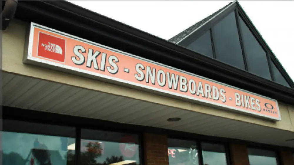 orange sign for skis, snowboards, and bikes