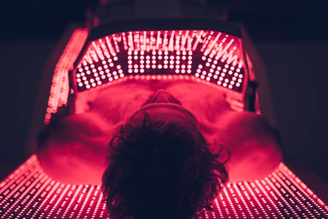 man in laying in red light