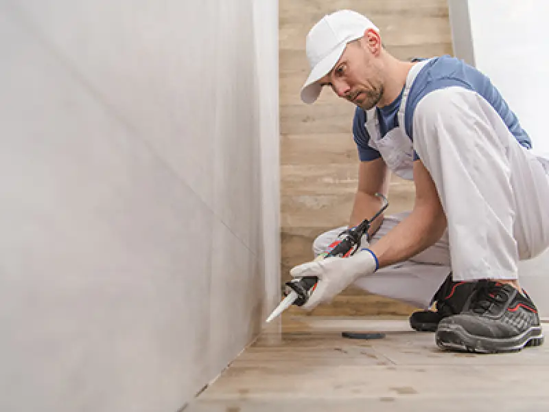 man caulking trim