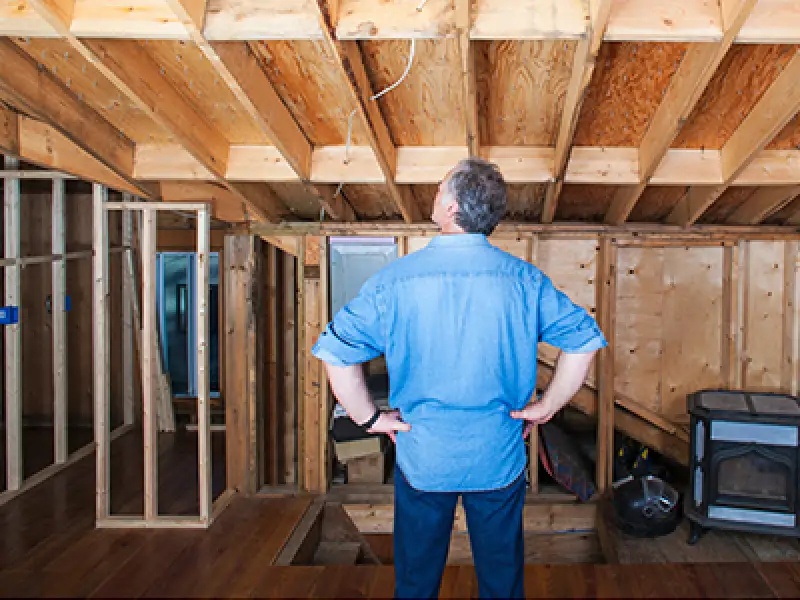 man inspecting his basement remodeling project