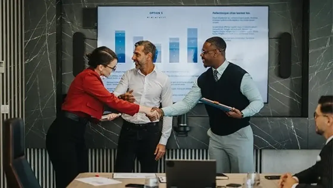 three business people in front of a presentation
