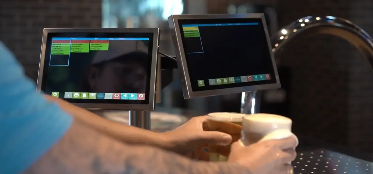 Bartender using Kitchen Armor POS touch screens