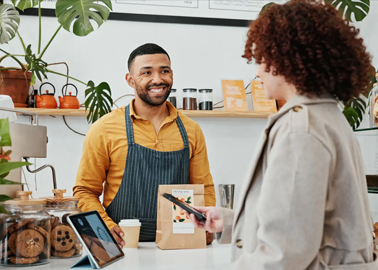 cashier smiling at customer at bakery shop